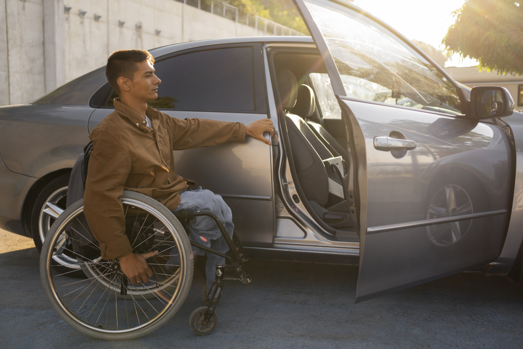 full-shot-man-wheelchair-near-car.jpg